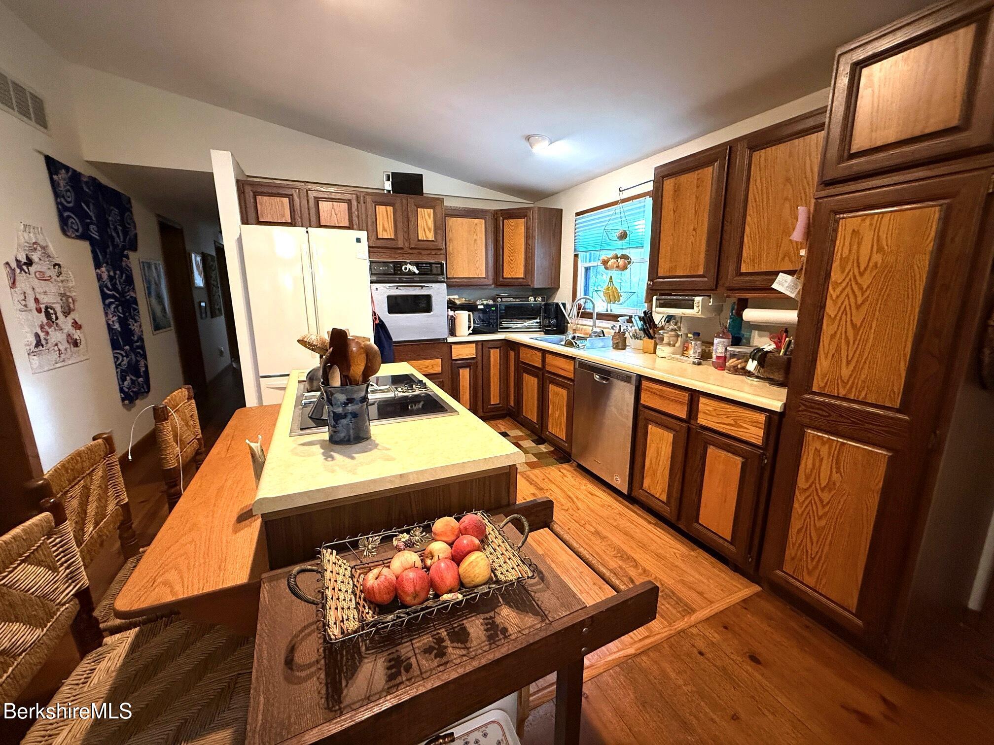 58 Evergreen Road Otis, MA 01029 - Photo 10 of 27 a kitchen with stainless steel appliances granite countertop sink stove refrigerator and a window