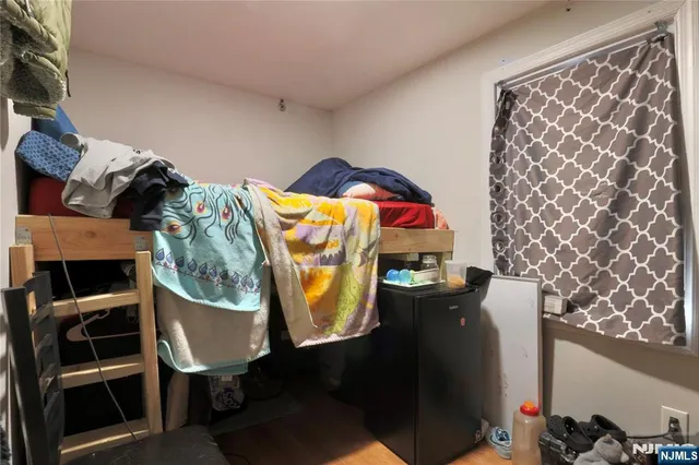 a bedroom with a bed and a chair