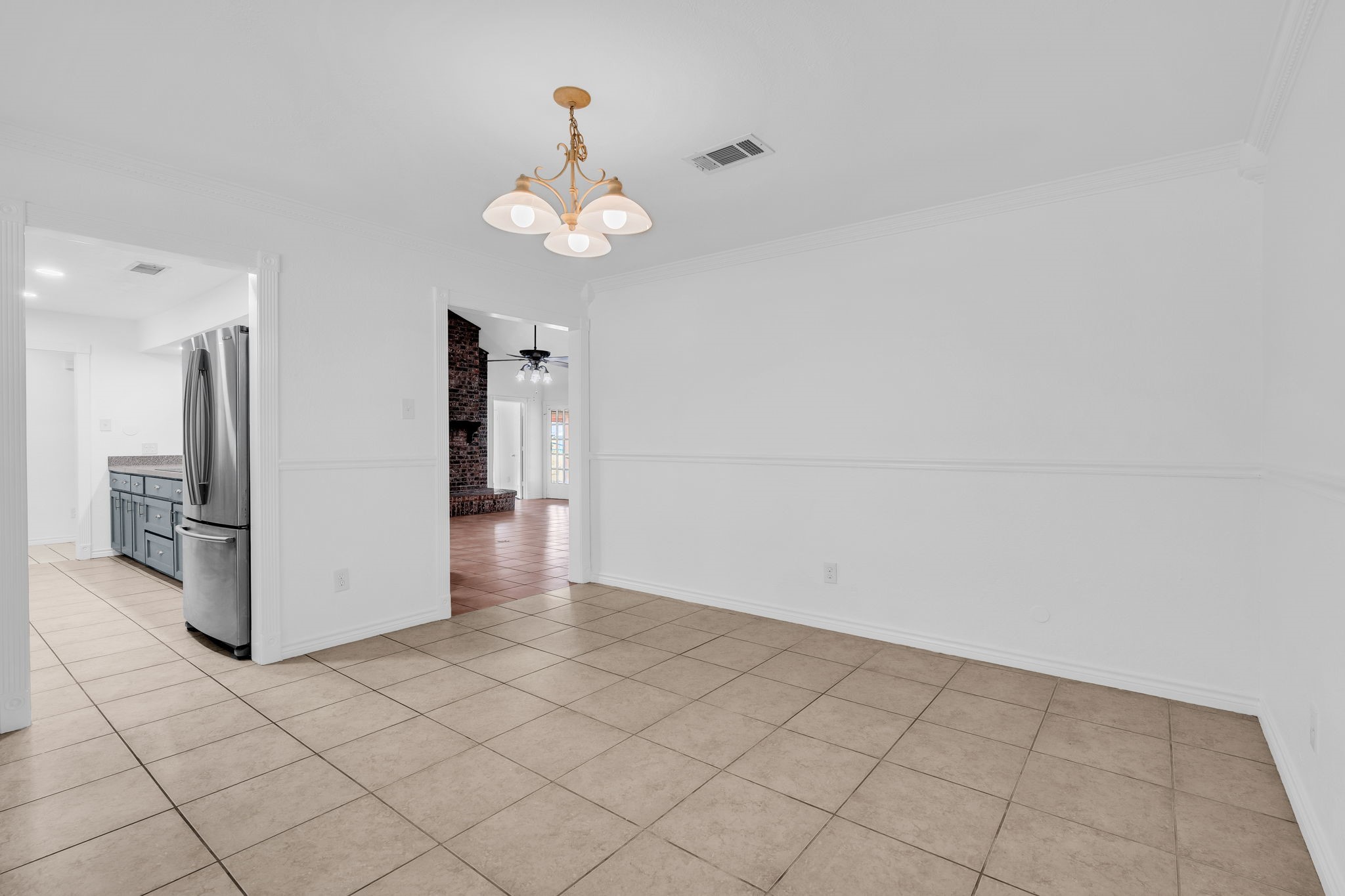 19811 Sagging Oaks Drive Spring, TX 77388 - Photo 11 of 36 an empty room with a chandelier