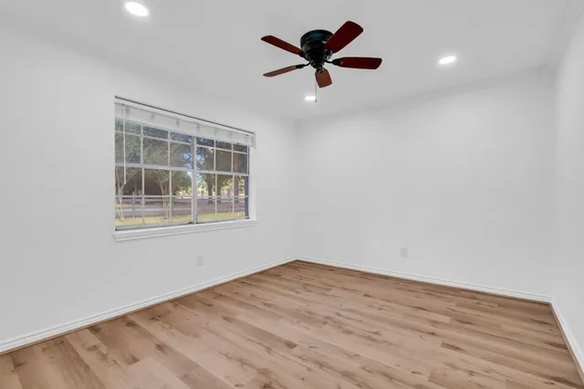 wooden floor in an empty room with a window