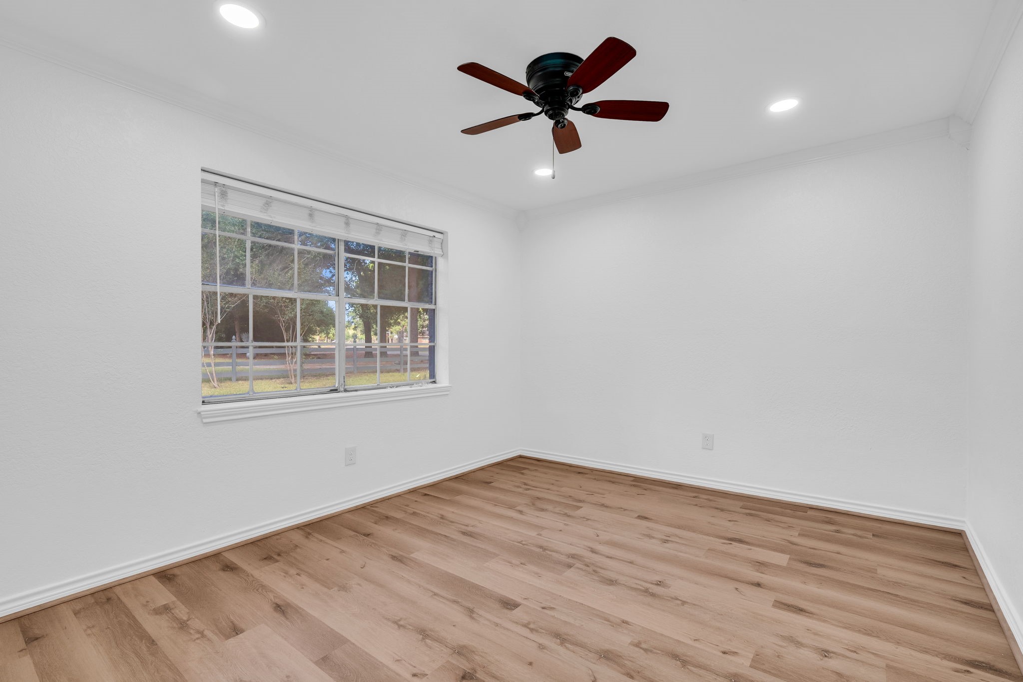 19811 Sagging Oaks Drive Spring, TX 77388 - Photo 21 of 36 wooden floor in an empty room with a window