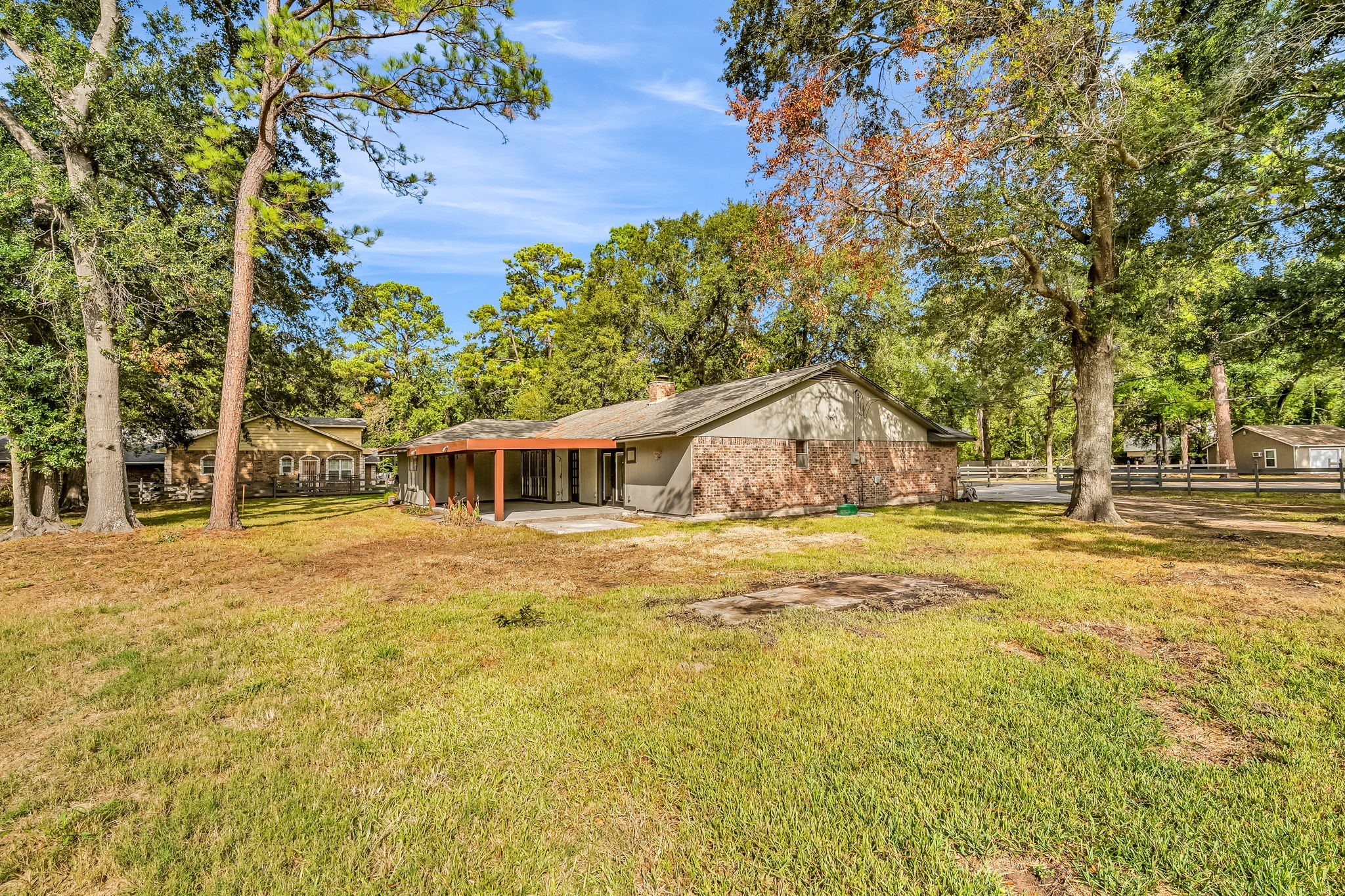19811 Sagging Oaks Drive Spring, TX 77388 - Photo 34 of 36 a backyard of a house with large trees and wooden fence