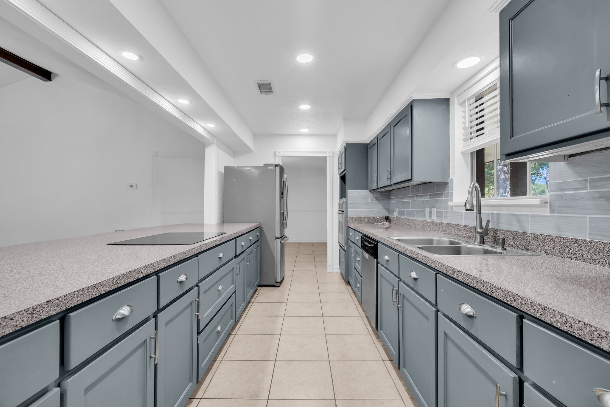 19811 Sagging Oaks Drive Spring, TX 77388 - Photo 7 of 36 a large kitchen with stainless steel appliances granite countertop a sink and cabinets