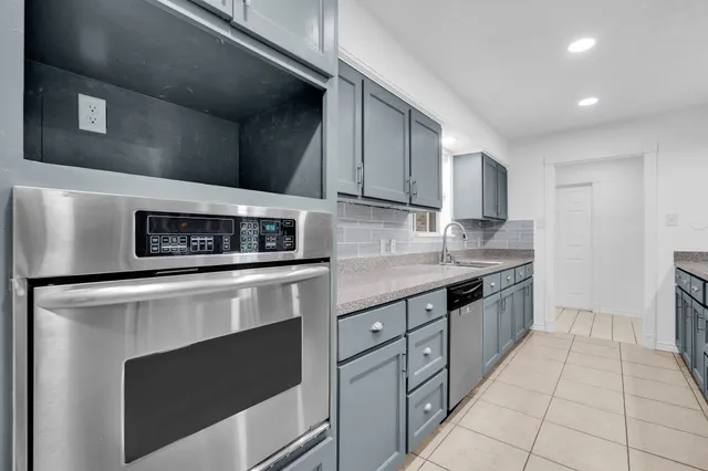 a kitchen with stainless steel appliances granite countertop a stove and a microwave