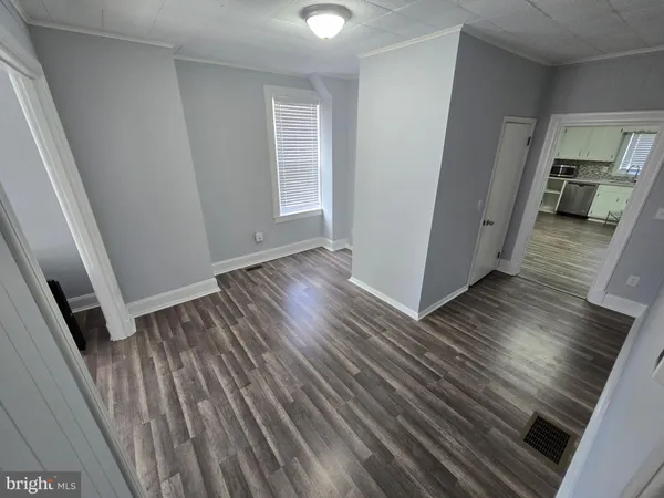 a view of a hallway view with wooden floor and staircase
