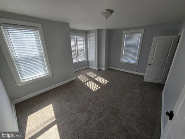 a view of an empty room with windows