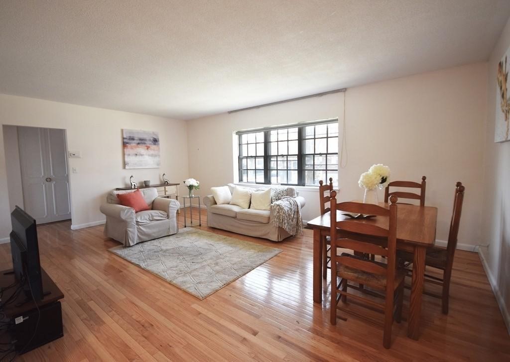 211 Lake Shore Road, Unit 2 Boston, MA 02135 - Photo 1 of 15 a bedroom with furniture and a couch