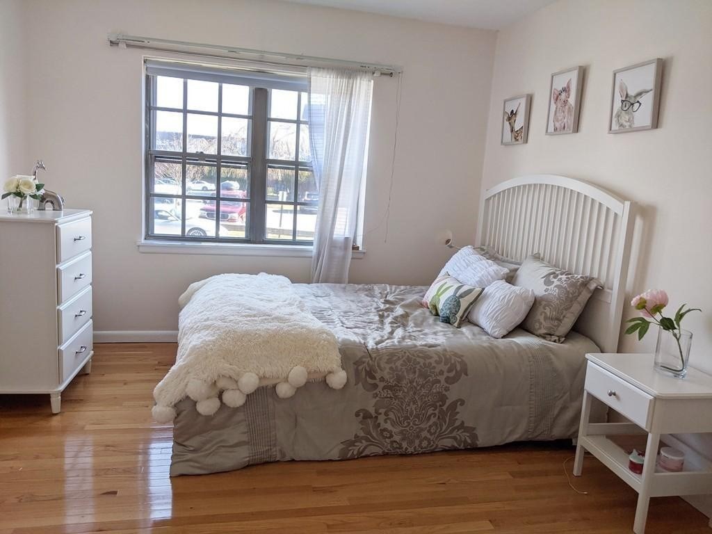 211 Lake Shore Road, Unit 2 Boston, MA 02135 - Photo 4 of 15 a bedroom with a bed and a window