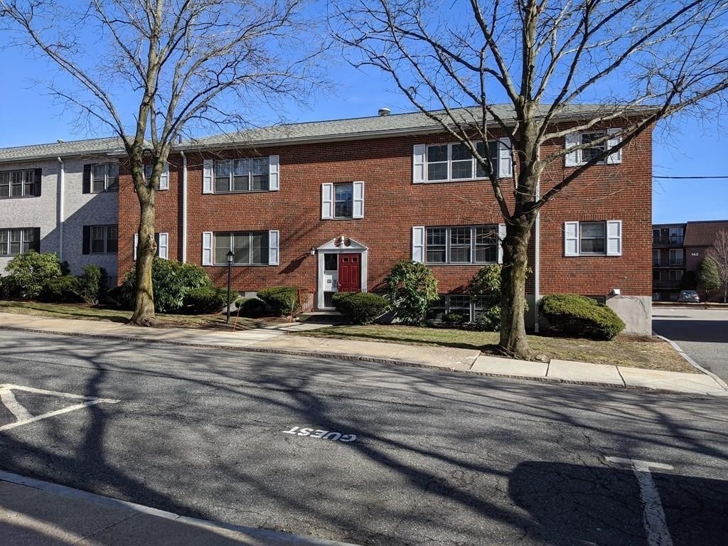 211 Lake Shore Road, Unit 2 Boston, MA 02135 - Photo 9 of 15 a front view of a house with a yard