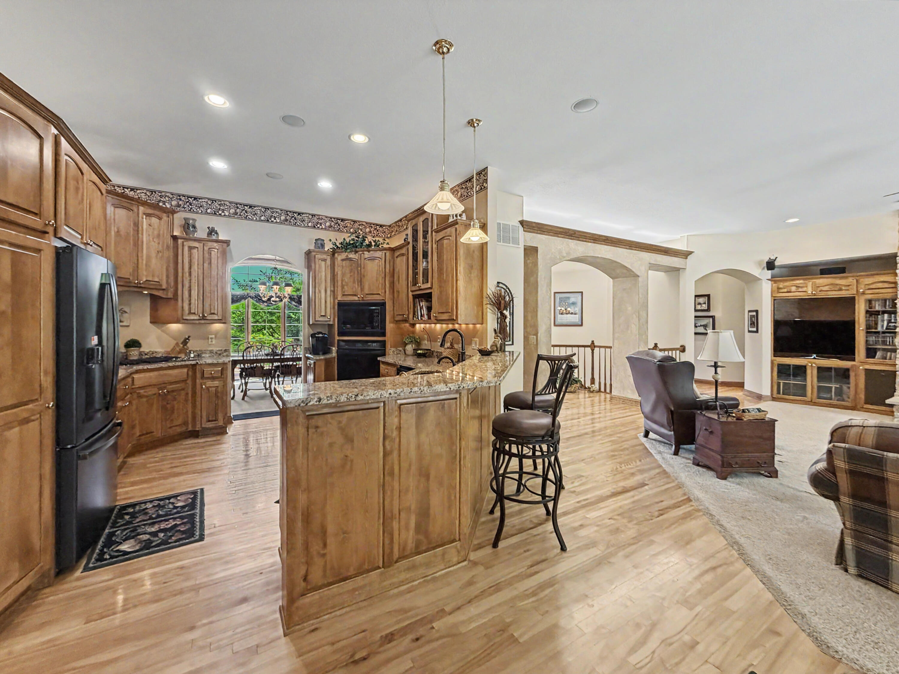 W291-s5245 Ridgefield Road Waukesha, WI 53189 - Photo 12 of 44 Open to the great room yet thoughtfully defined, the kitchen features rich Birch cabinetry, Birch floors, granite countertops, a large center island, and gas cooktop.