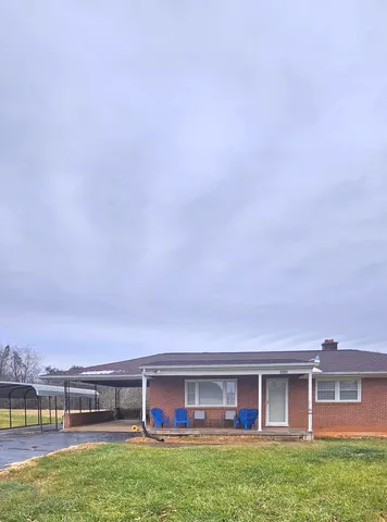 a view of house with outdoor space and deck