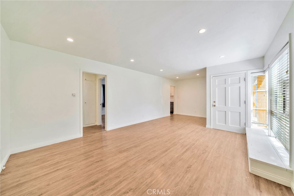 5729 Clemson Street Los Angeles, CA 90016 - Photo 12 of 26 a view of an empty room with wooden floor and a window