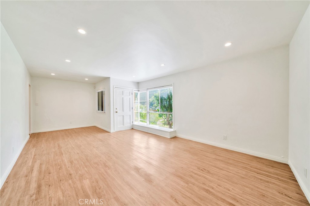 5729 Clemson Street Los Angeles, CA 90016 - Photo 13 of 26 a view of an empty room with wooden floor and a window