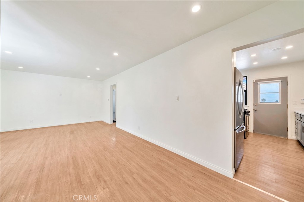 5729 Clemson Street Los Angeles, CA 90016 - Photo 14 of 26 wooden floor in an empty room with a window