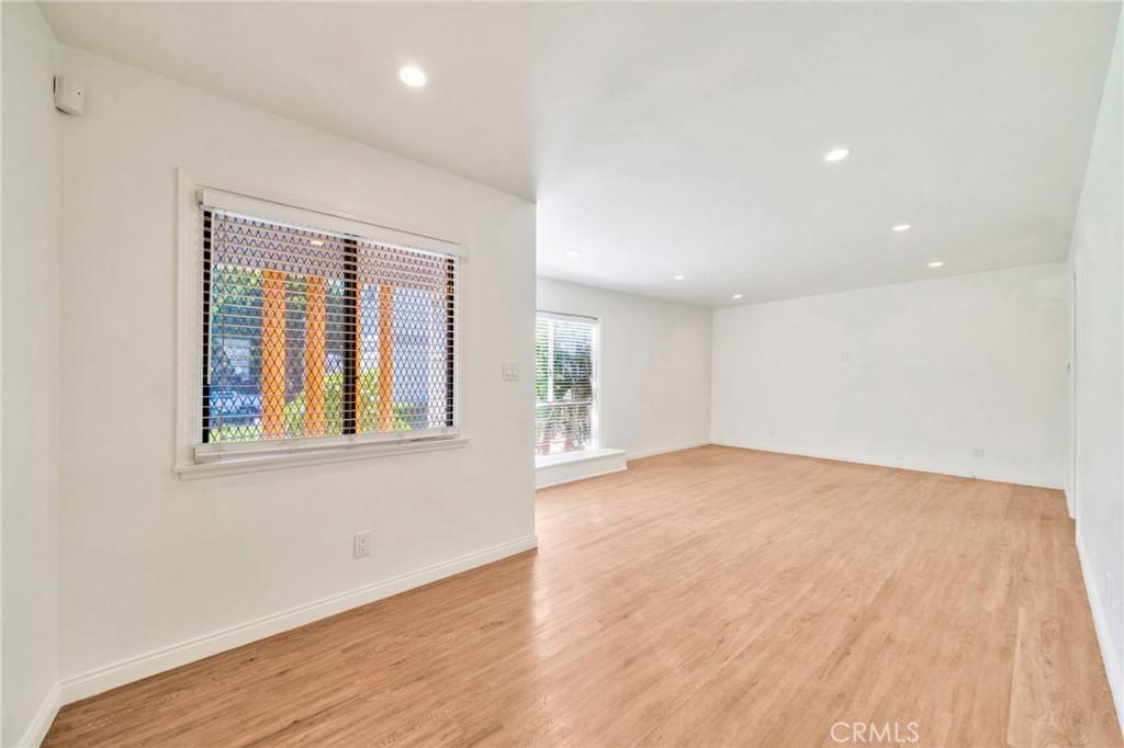 5729 Clemson Street Los Angeles, CA 90016 - Photo 15 of 26 a view of an empty room with wooden floor and a window