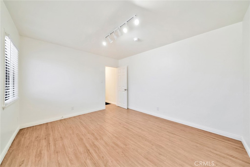5729 Clemson Street Los Angeles, CA 90016 - Photo 22 of 26 a view of an empty room with wooden floor