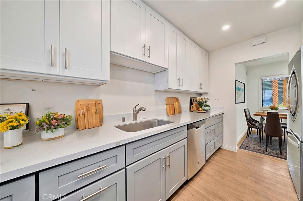 5729 Clemson Street Los Angeles, CA 90016 - Photo 7 of 26 a kitchen with cabinets and window