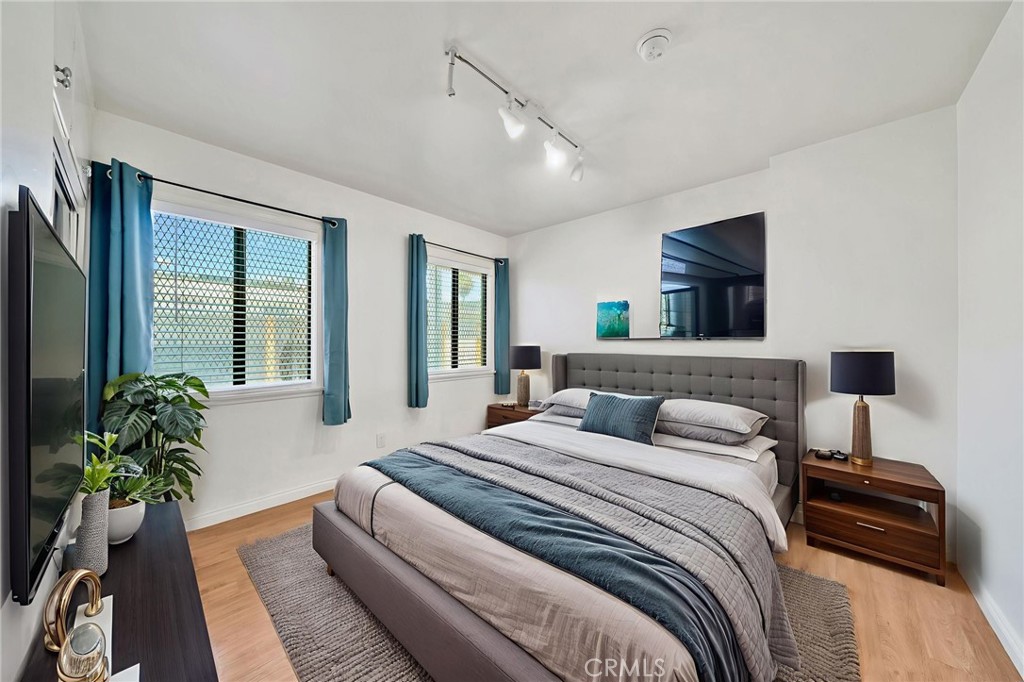 5729 Clemson Street Los Angeles, CA 90016 - Photo 8 of 26 a bedroom with a bed and a potted plant