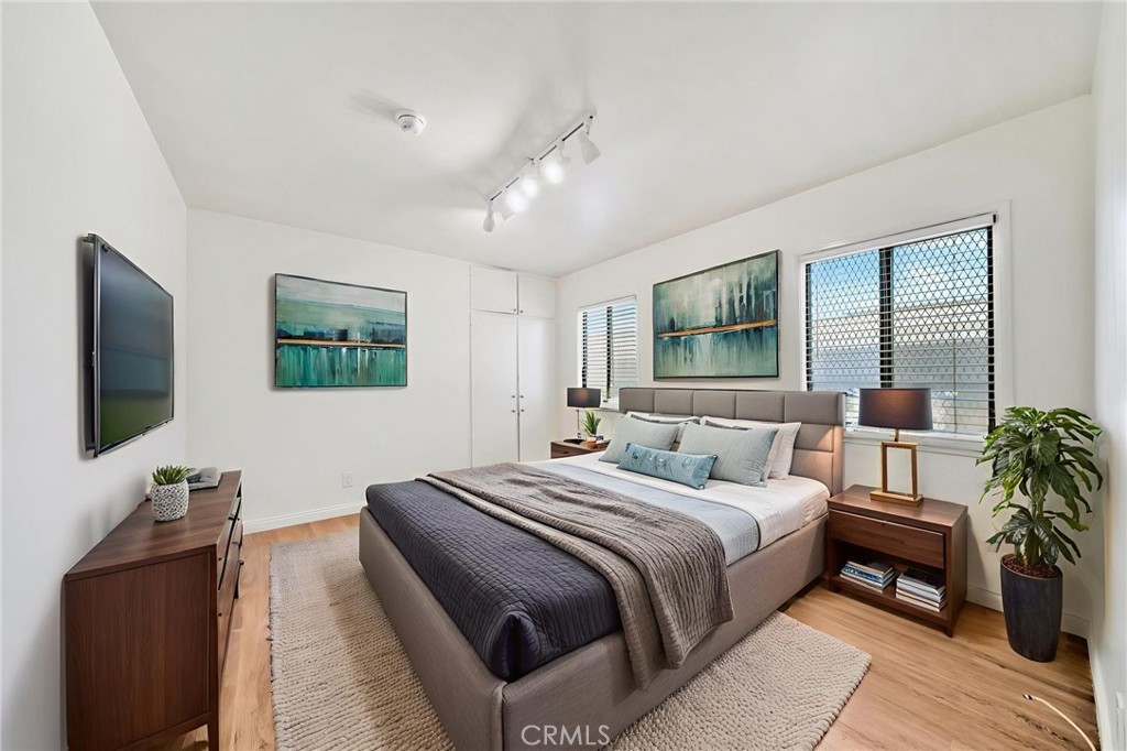5729 Clemson Street Los Angeles, CA 90016 - Photo 9 of 26 a bedroom with a bed and a flat screen television