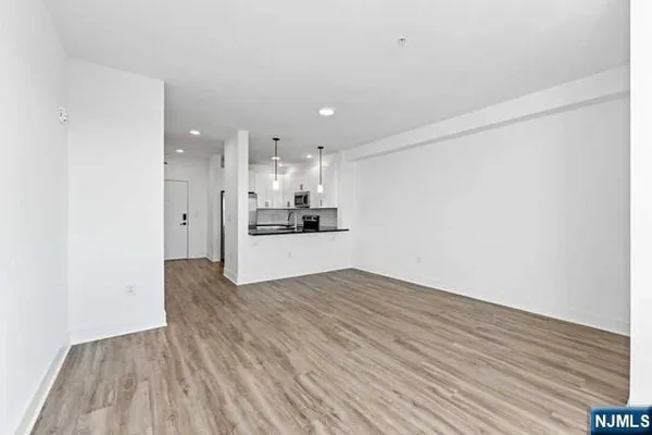 a view of a kitchen with wooden floor