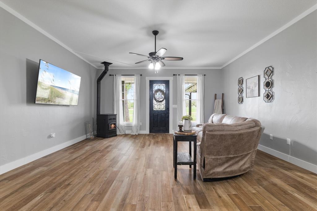 5480 New Hope Road Aubrey, TX 76227 - Photo 39 of 39 a living room with furniture and a wooden floor