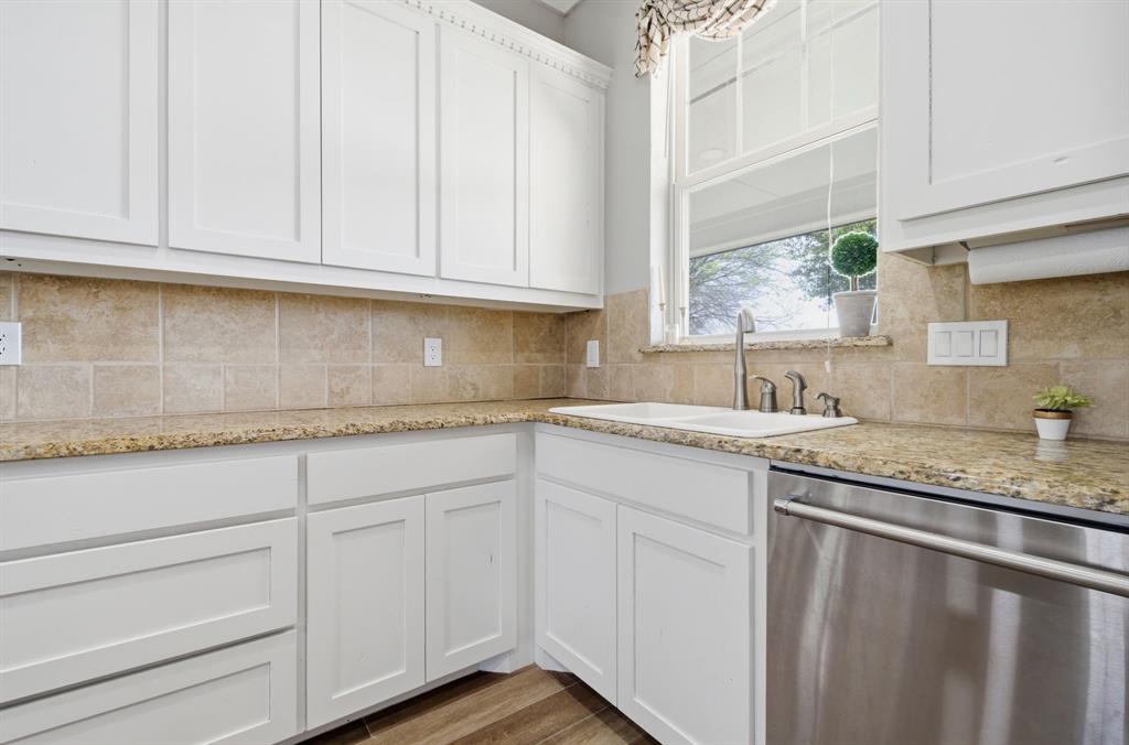 5480 New Hope Road Aubrey, TX 76227 - Photo 13 of 39 a kitchen with granite countertop white cabinets white appliances and a sink