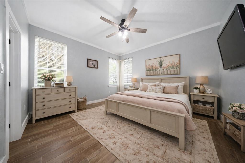 5480 New Hope Road Aubrey, TX 76227 - Photo 15 of 39 a spacious bedroom with a bed and a tv