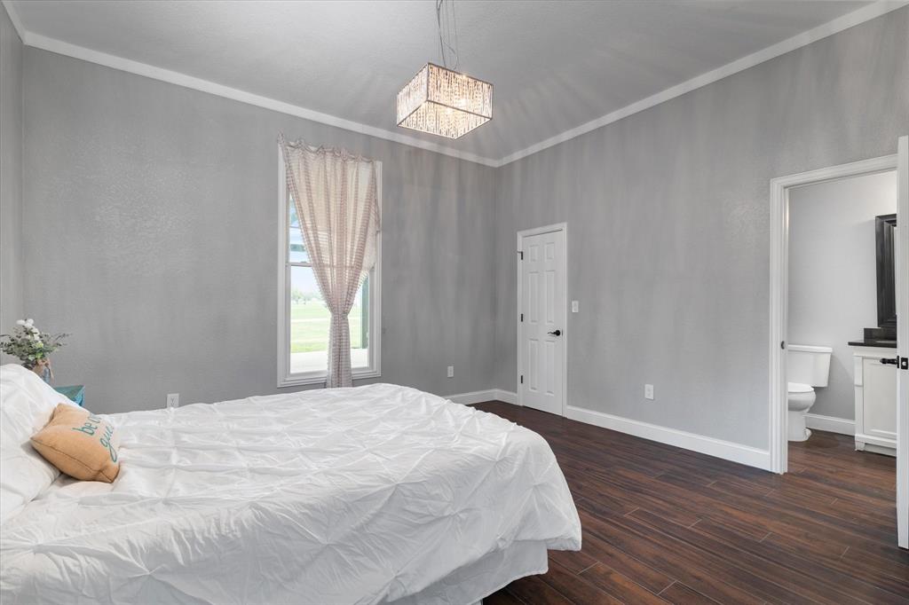 5480 New Hope Road Aubrey, TX 76227 - Photo 18 of 39 a bedroom with a bed and a window