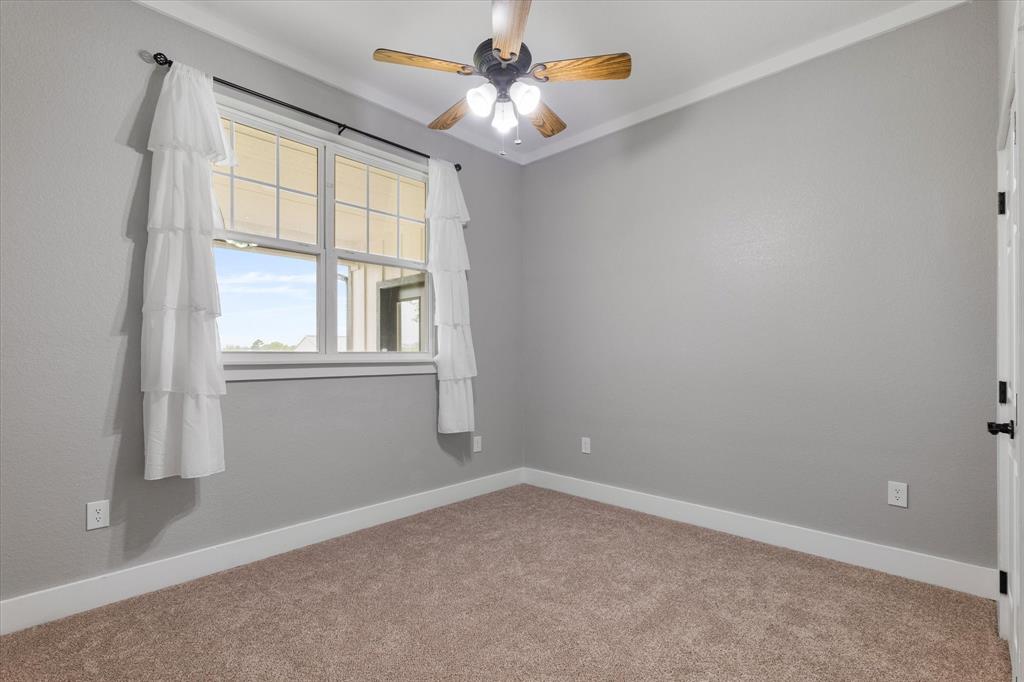 5480 New Hope Road Aubrey, TX 76227 - Photo 20 of 39 an empty room with windows and chandelier fan