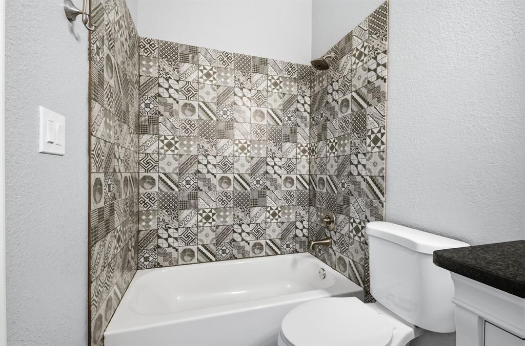 5480 New Hope Road Aubrey, TX 76227 - Photo 21 of 39 a bathroom with a toilet and a bathtub
