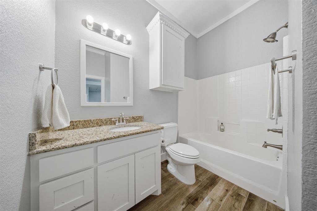 5480 New Hope Road Aubrey, TX 76227 - Photo 23 of 39 a bathroom with a granite countertop sink toilet and shower