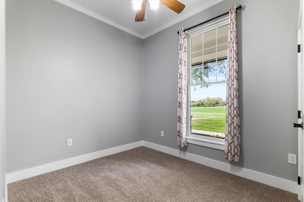 5480 New Hope Road Aubrey, TX 76227 - Photo 22 of 39 an empty room with windows and closet