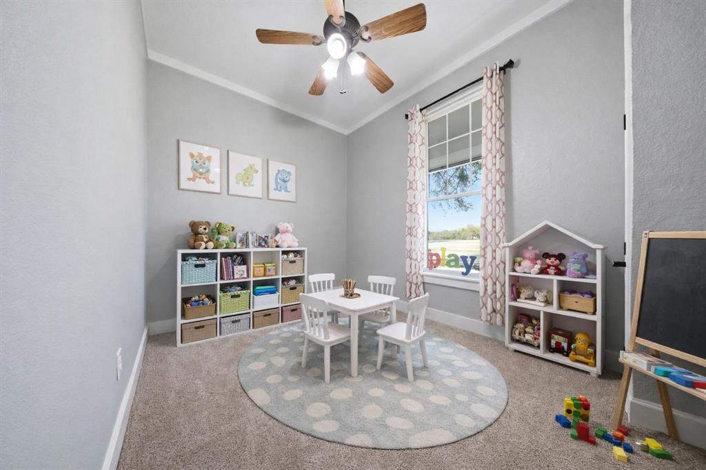 5480 New Hope Road Aubrey, TX 76227 - Photo 24 of 39 a work room with furniture and a flat screen tv