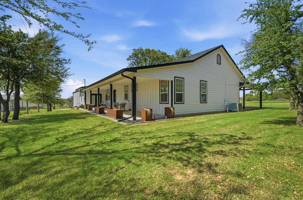 5480 New Hope Road Aubrey, TX 76227 - Photo 28 of 39 a view of a house with a yard