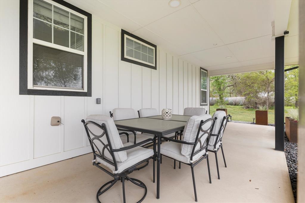 5480 New Hope Road Aubrey, TX 76227 - Photo 30 of 39 a view of a dining room with furniture and a window
