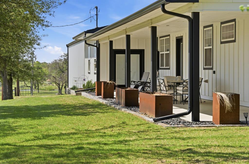 5480 New Hope Road Aubrey, TX 76227 - Photo 31 of 39 a front view of a house with a yard