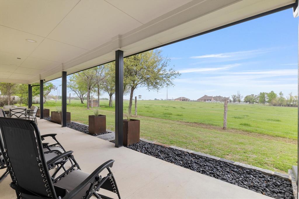 5480 New Hope Road Aubrey, TX 76227 - Photo 31 of 39 a view of a living room and floor to ceiling window