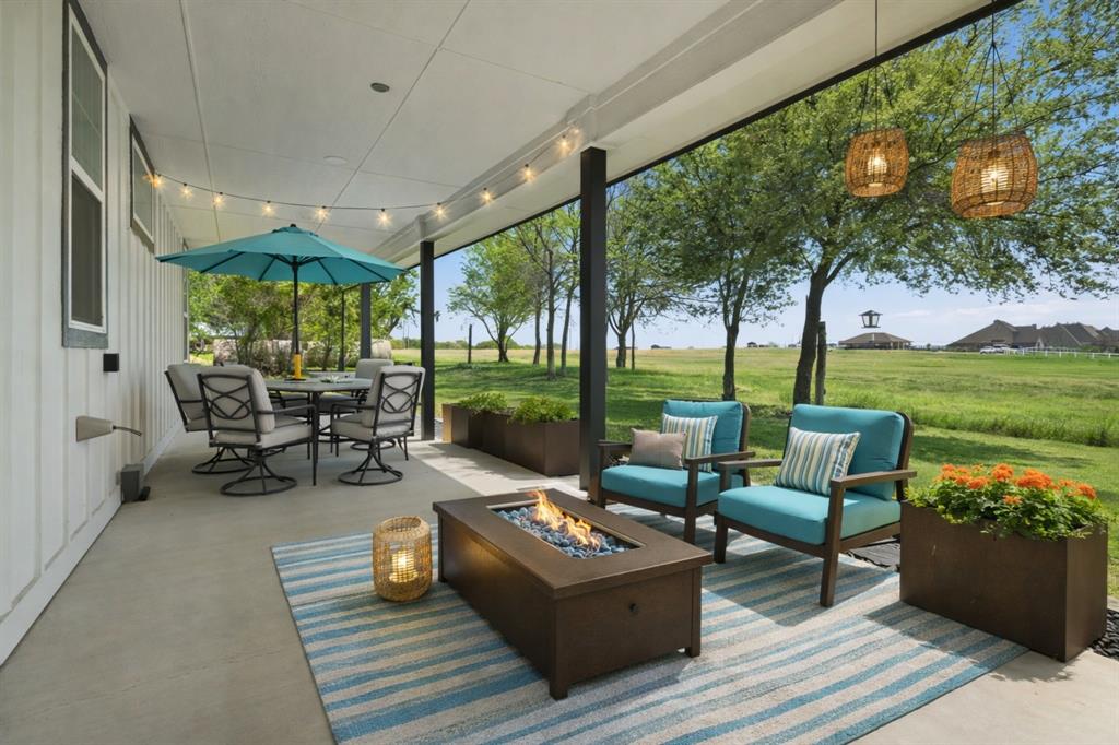 5480 New Hope Road Aubrey, TX 76227 - Photo 32 of 39 a living room with patio furniture and a garden