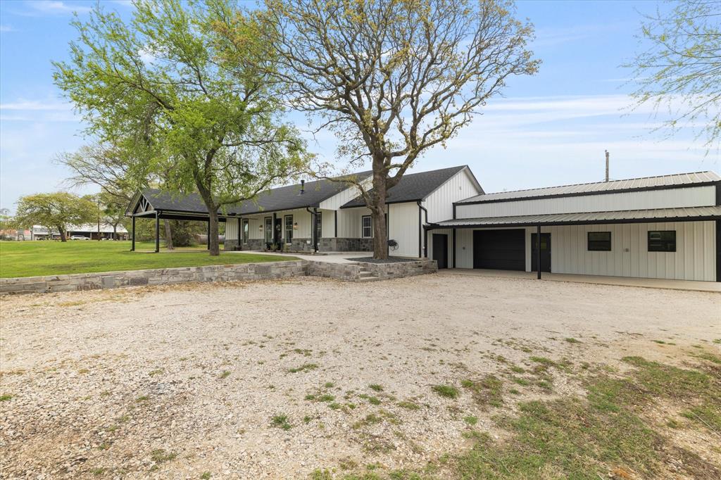 5480 New Hope Road Aubrey, TX 76227 - Photo 32 of 39 a front view of a house with a yard and garage