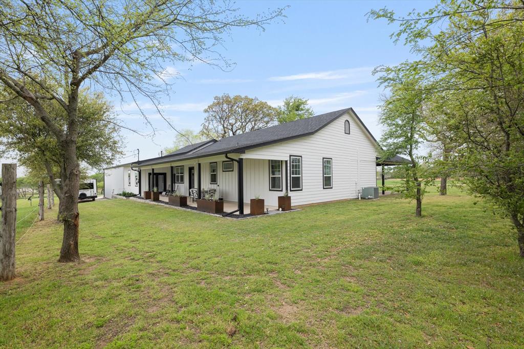 5480 New Hope Road Aubrey, TX 76227 - Photo 33 of 39 a view of a house and a yard with green space