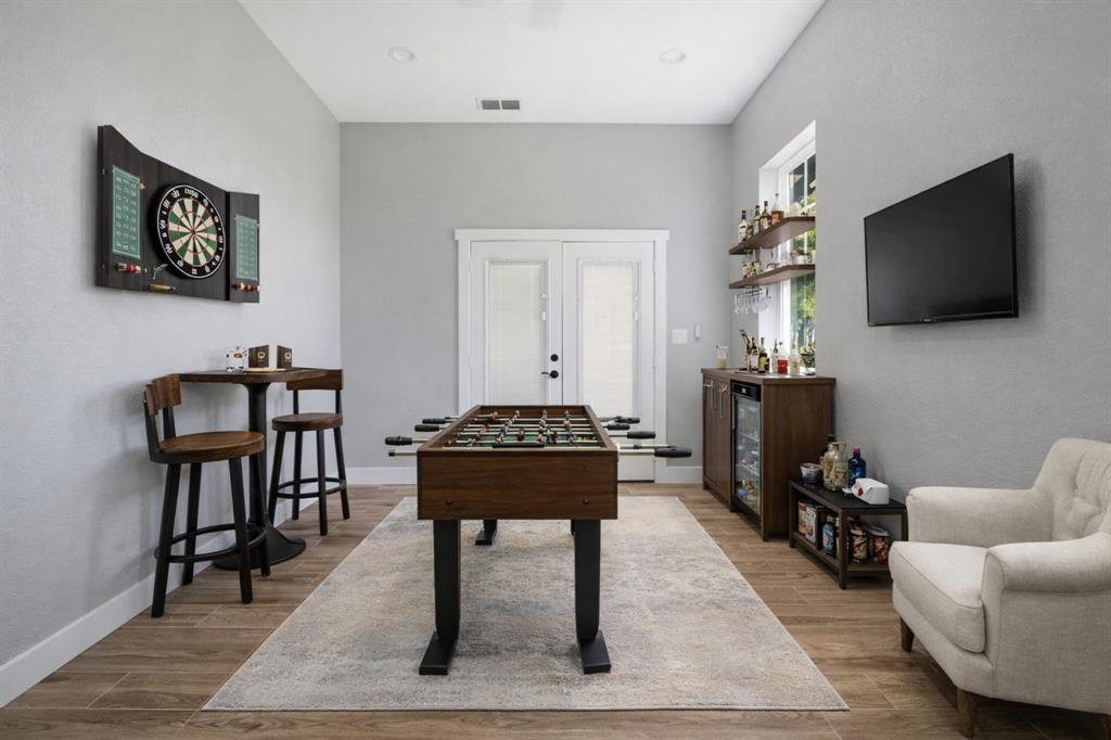 5480 New Hope Road Aubrey, TX 76227 - Photo 36 of 39 a living room with furniture a flat screen tv and a fireplace