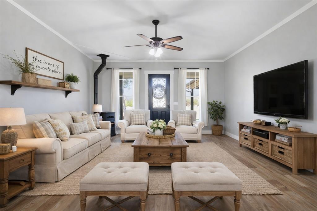5480 New Hope Road Aubrey, TX 76227 - Photo 9 of 39 a living room with furniture and a flat screen tv