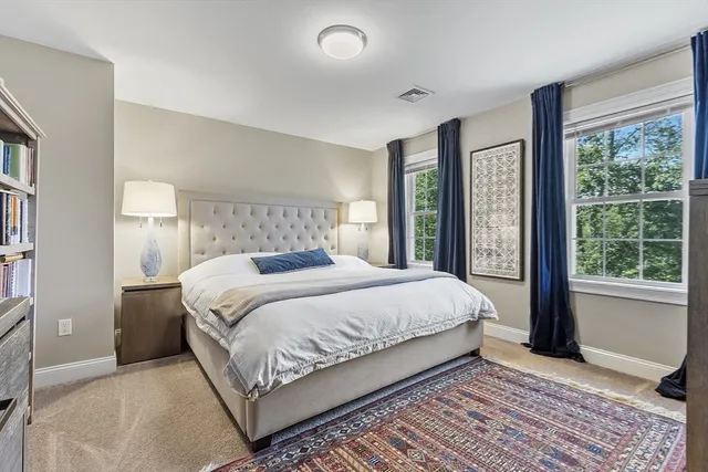 a bedroom with a large bed and a large window