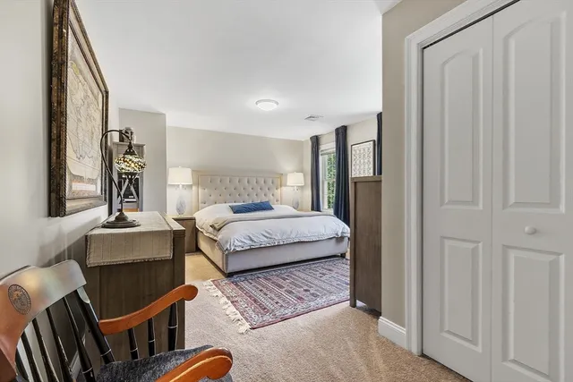 a bedroom with a bed couch and a window