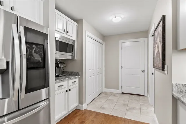 a kitchen with stainless steel appliances granite countertop a refrigerator and a stove