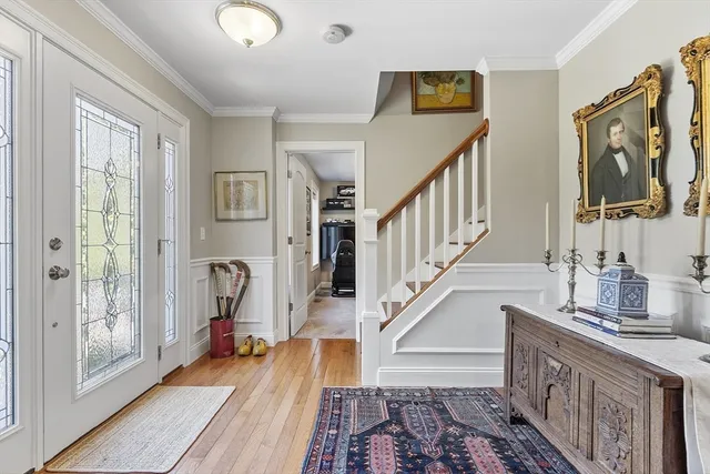 a view of entryway and hall with wooden floor