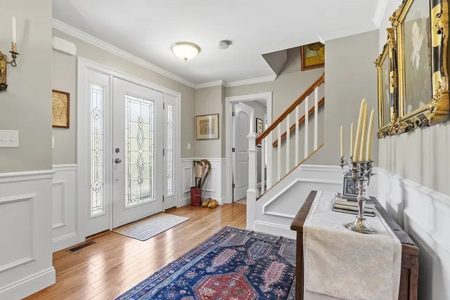 a view of an entryway with wooden floor and windows