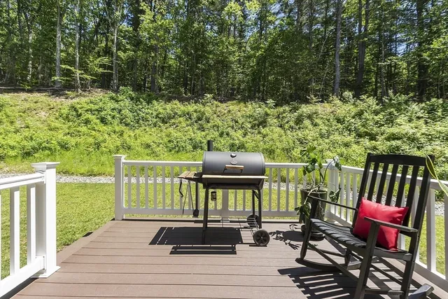 a view of a chairs and table on the wooden deck