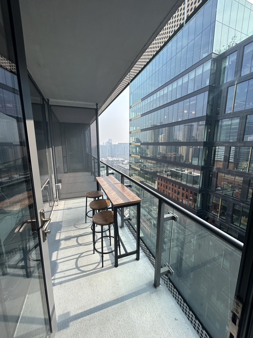 730 West Couch Place, Unit 1805 Chicago, IL 60661 - Photo 6 of 9 a view of a balcony with chairs