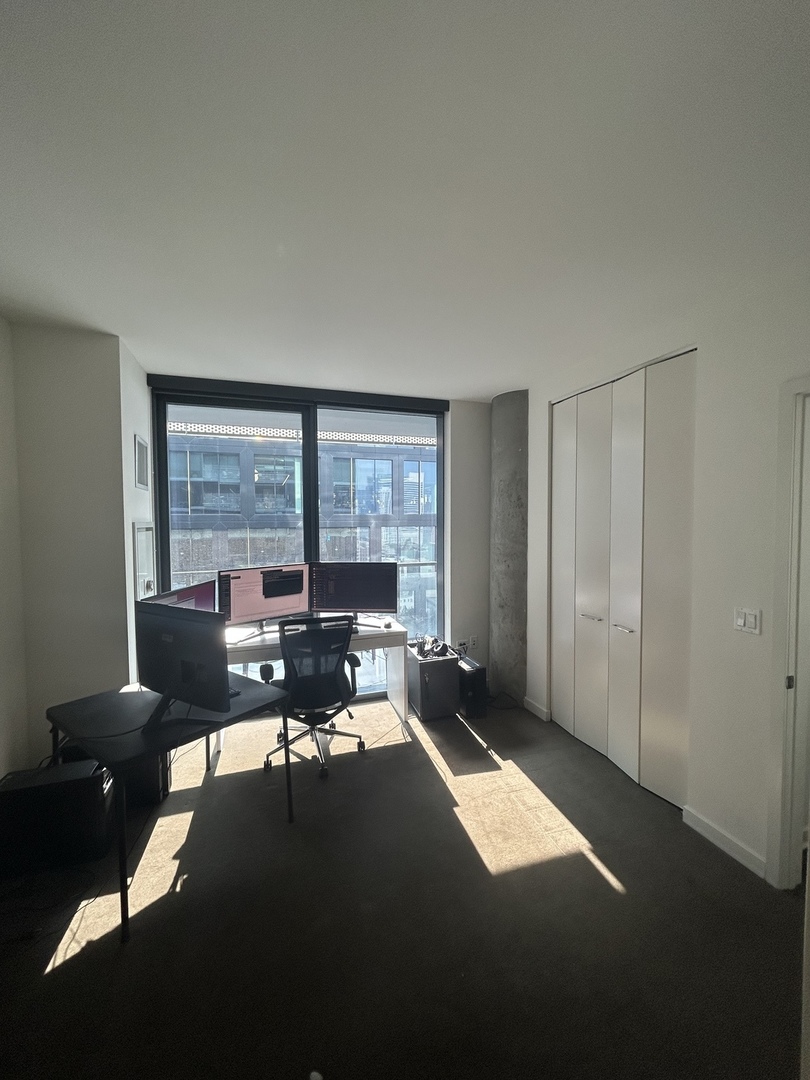 730 West Couch Place, Unit 1805 Chicago, IL 60661 - Photo 7 of 9 a living room with furniture and a large window